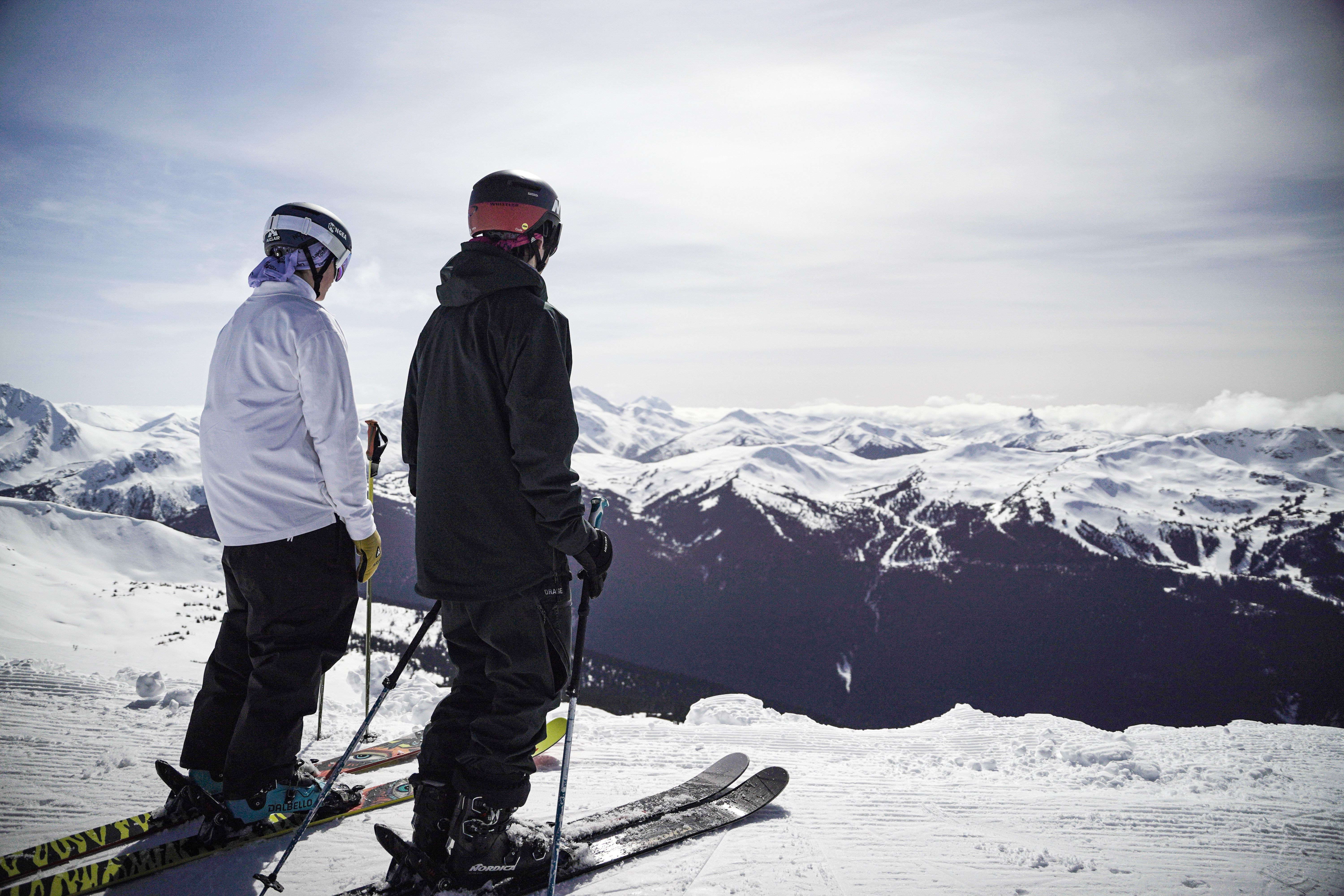 Ski boots, skis, and snowboard gear laid out ready for a season